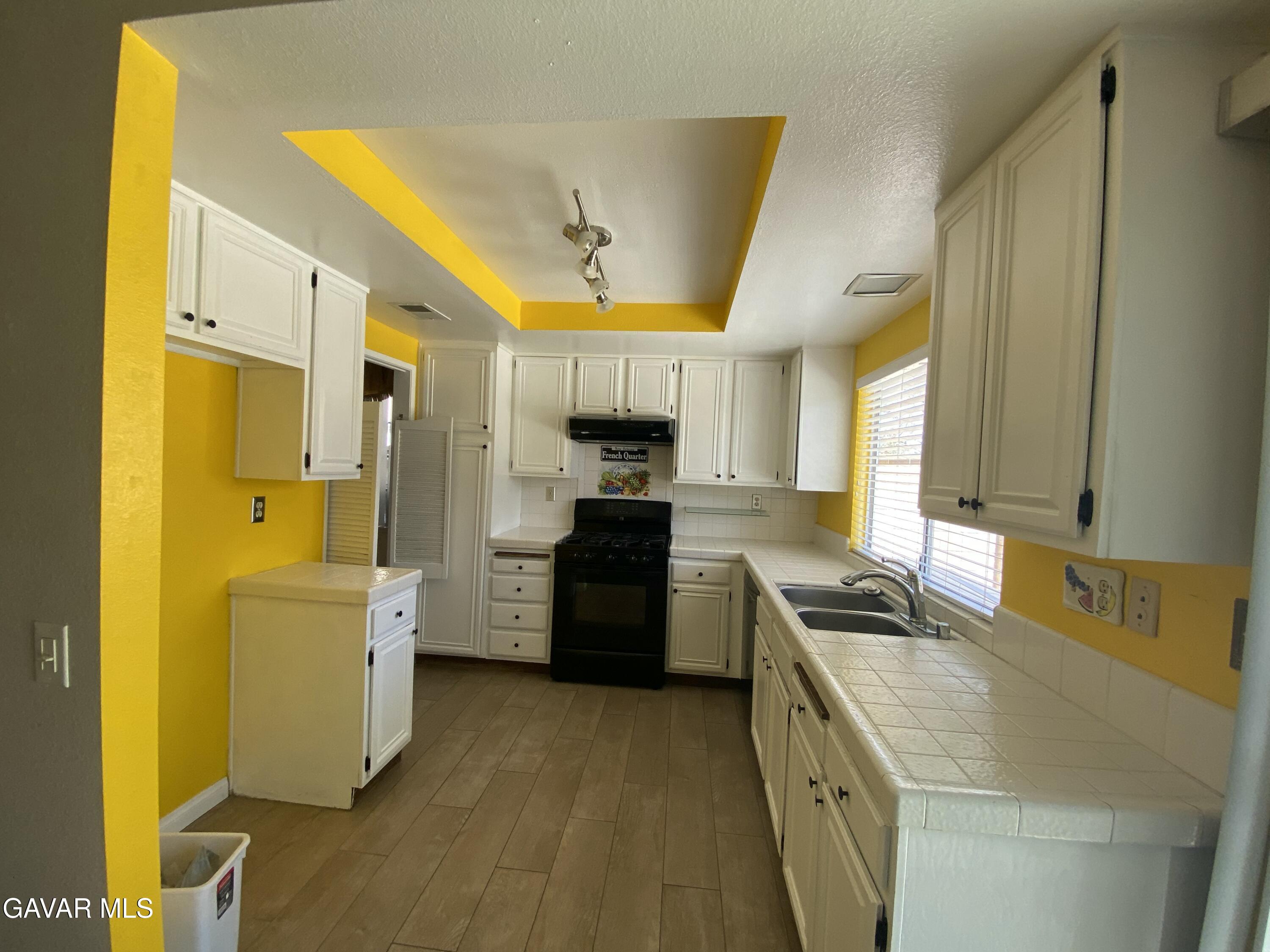 44034 4th Street East Lancaster, CA 93535 - Photo 5 of 14 a kitchen with a sink appliances and cabinets