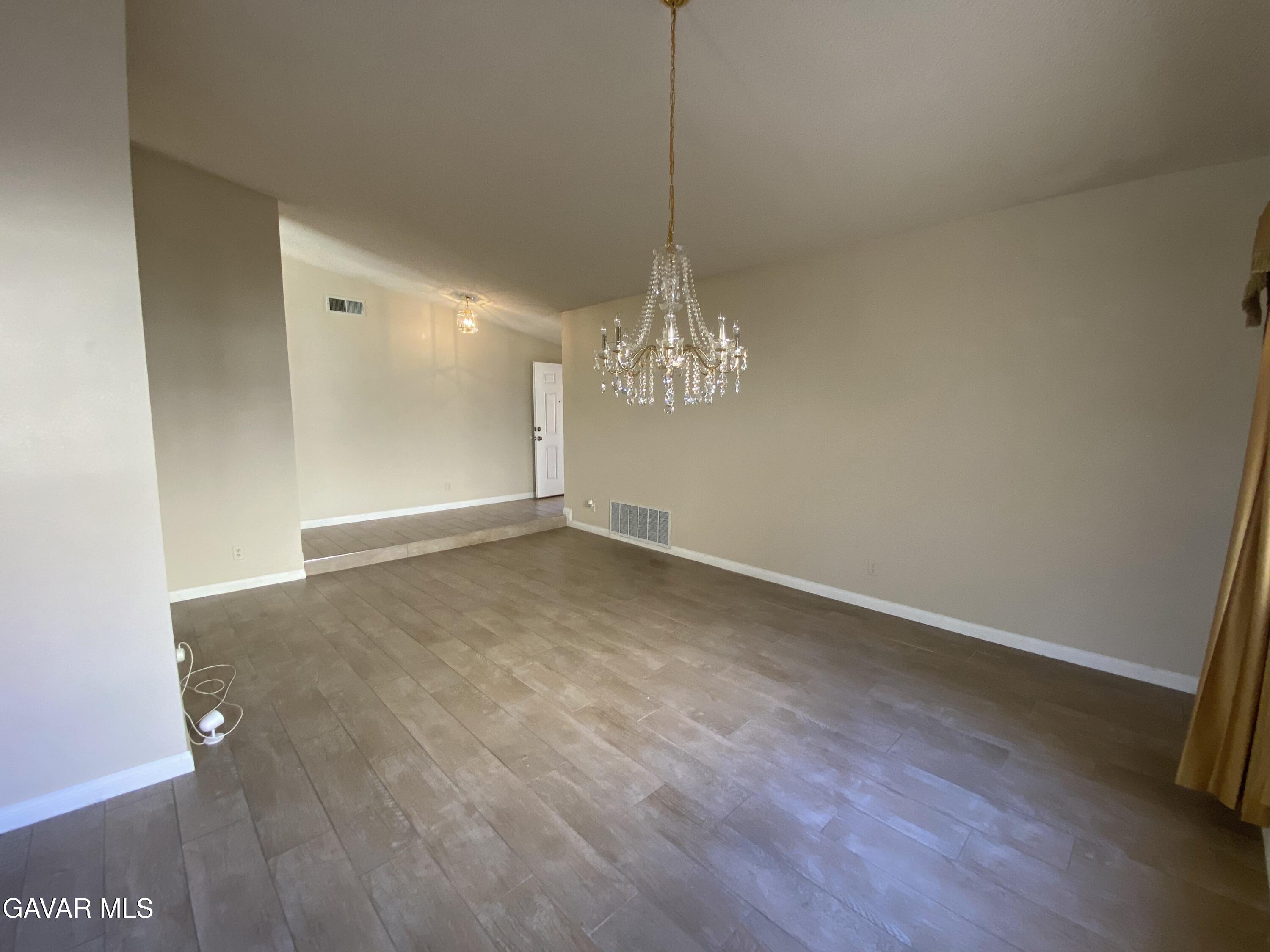 44034 4th Street East Lancaster, CA 93535 - Photo 8 of 14 a view of a room with wooden floor and a ceiling fan