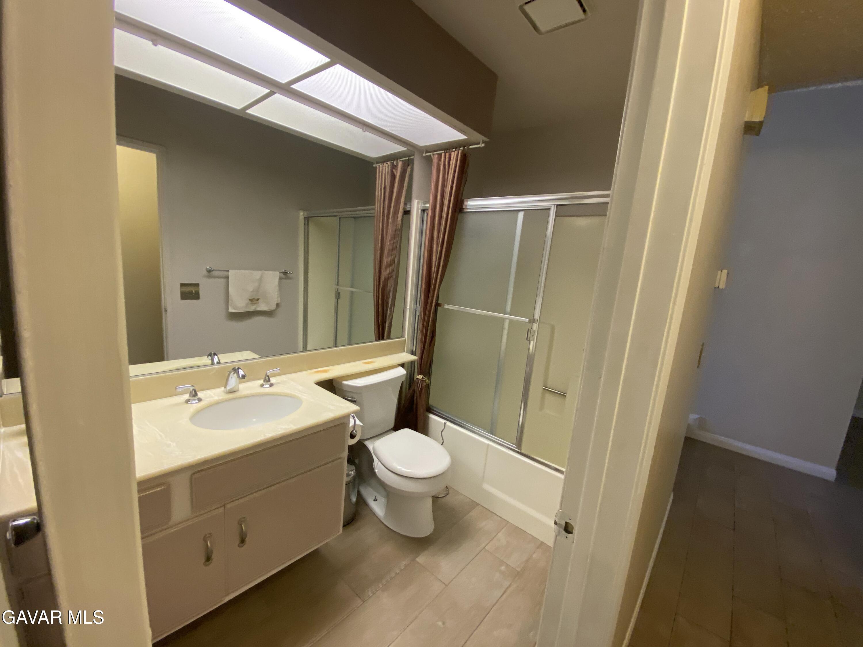 44034 4th Street East Lancaster, CA 93535 - Photo 9 of 14 a bathroom with a sink a toilet a mirror and shower