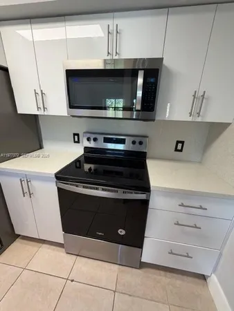 a kitchen with a stove and a microwave