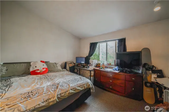 a bedroom with a bed and a desk