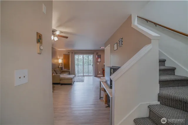 a living room with furniture and a wooden floor