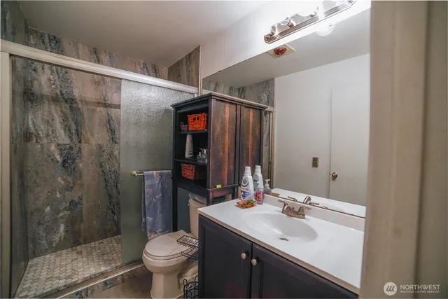 a bathroom with a sink toilet and shower