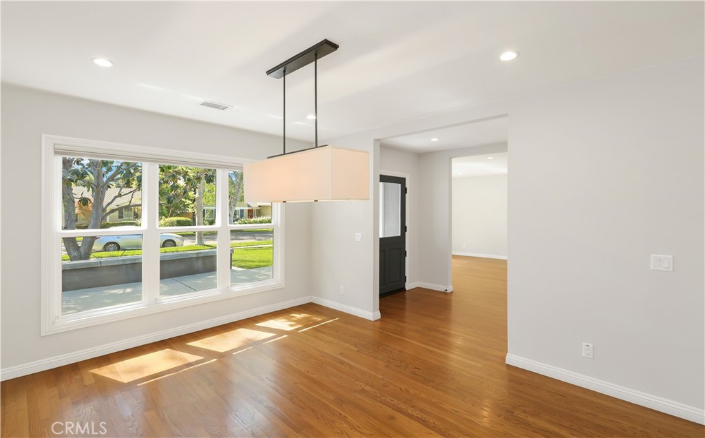 933 West Riviera Drive Santa Ana, CA 92706 - Photo 13 of 43 a view of empty room with wooden floor and fan