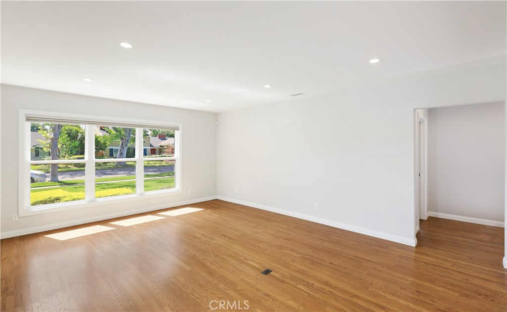 933 West Riviera Drive Santa Ana, CA 92706 - Photo 14 of 43 a view of an empty room with wooden floor and a window