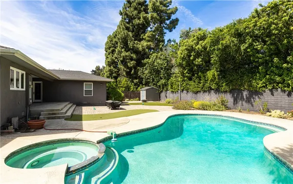 a view of a swimming pool with a patio