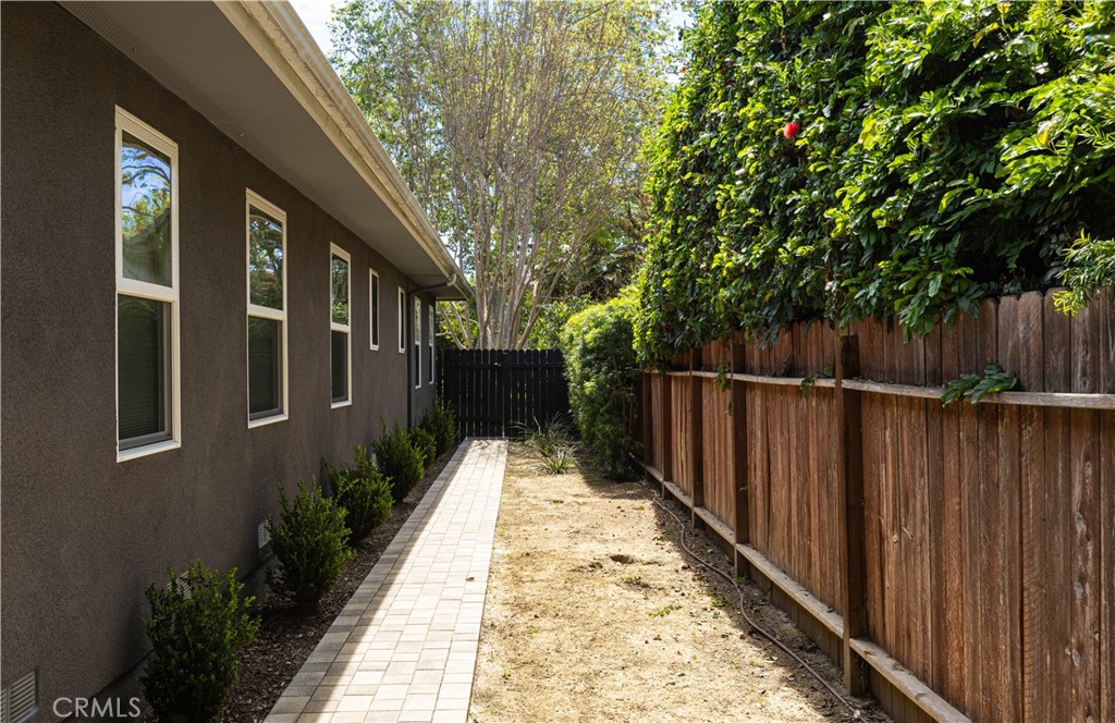 933 West Riviera Drive Santa Ana, CA 92706 - Photo 24 of 43 a view of a house with backyard and wooden fence