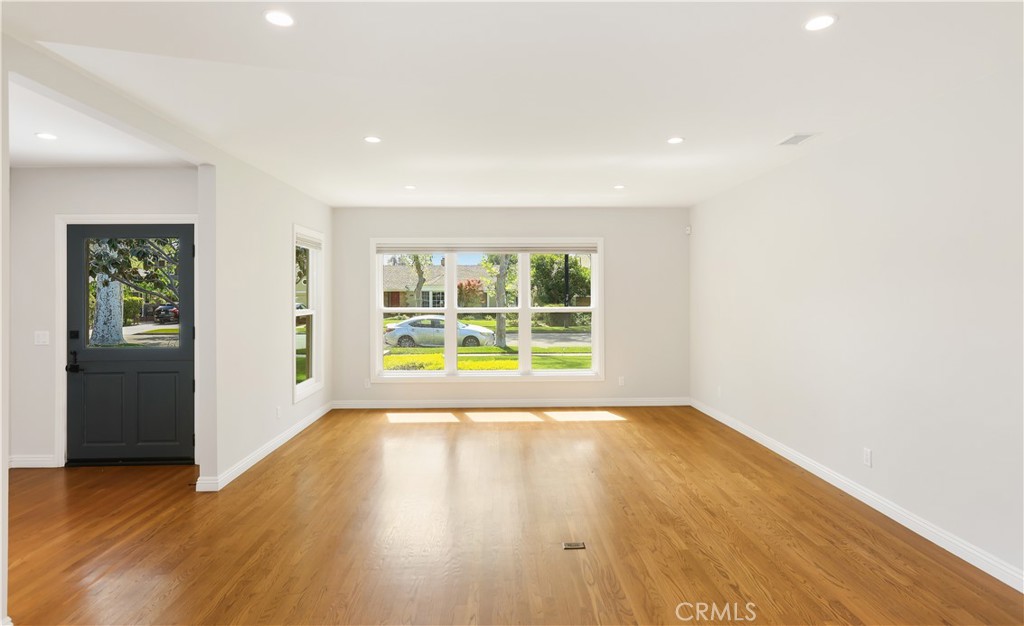 933 West Riviera Drive Santa Ana, CA 92706 - Photo 27 of 43 a view of an empty room with wooden floor and a window