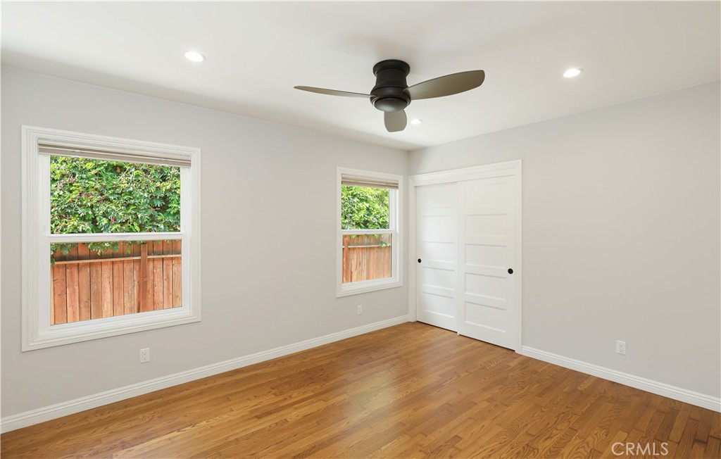 933 West Riviera Drive Santa Ana, CA 92706 - Photo 39 of 43 a view of an empty room with wooden floor and a window