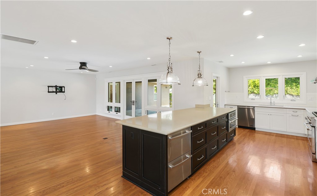 933 West Riviera Drive Santa Ana, CA 92706 - Photo 7 of 43 a kitchen with kitchen island a sink wooden floor and counter space