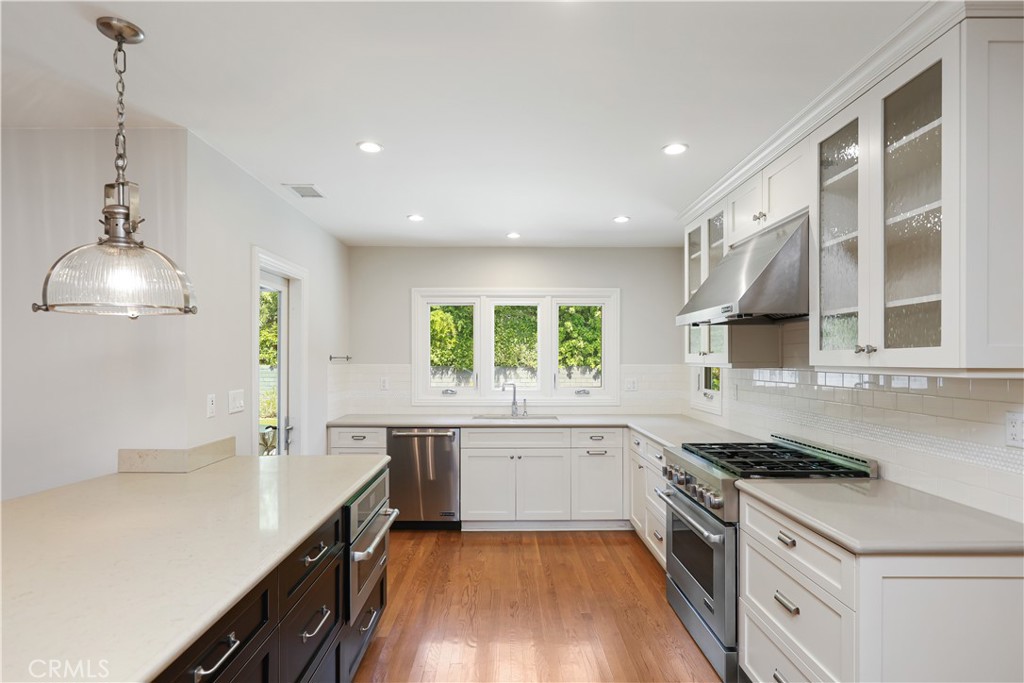 933 West Riviera Drive Santa Ana, CA 92706 - Photo 9 of 43 a kitchen with a sink stove and cabinets