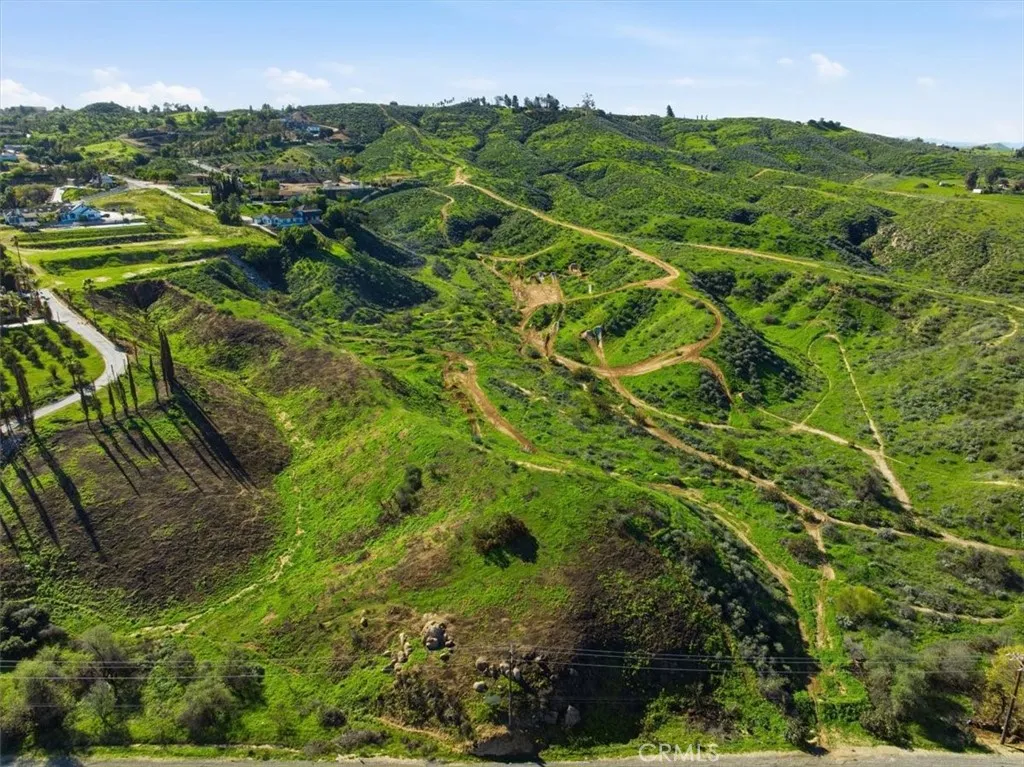 0 Sunrise Mesa Riverside, CA 92504 - Photo 3 of 11 a view of a lush green forest with houses in the back