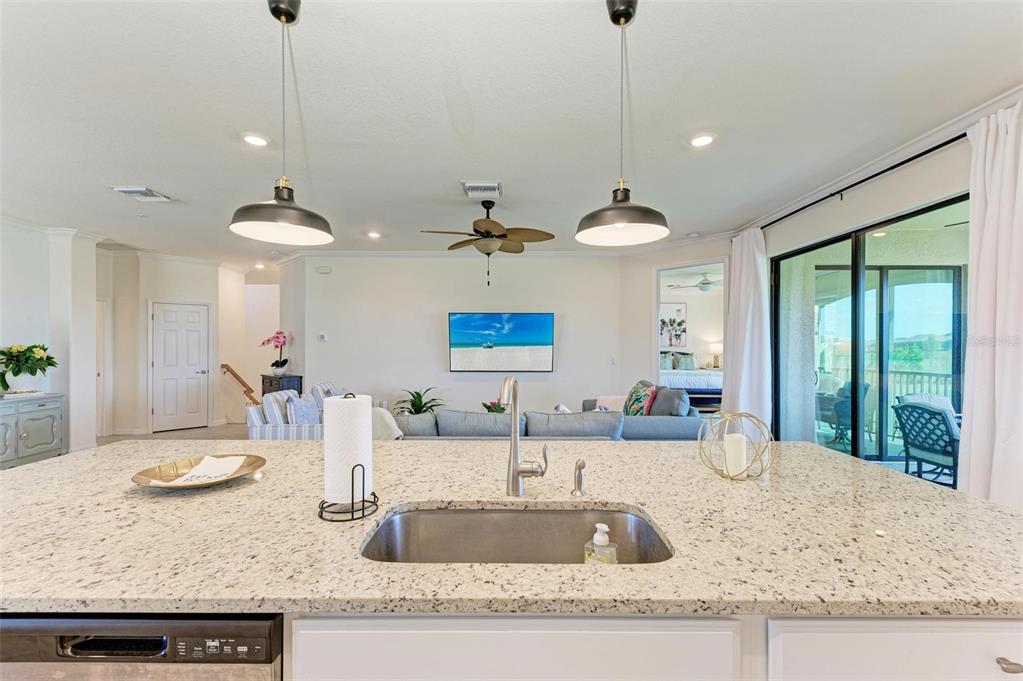 6086 Worsham Lane, Unit 103 Bradenton, FL 34211 - Photo 15 of 60 a kitchen with granite countertop sink and living room view