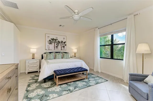 a spacious bedroom with a bed and a chandelier