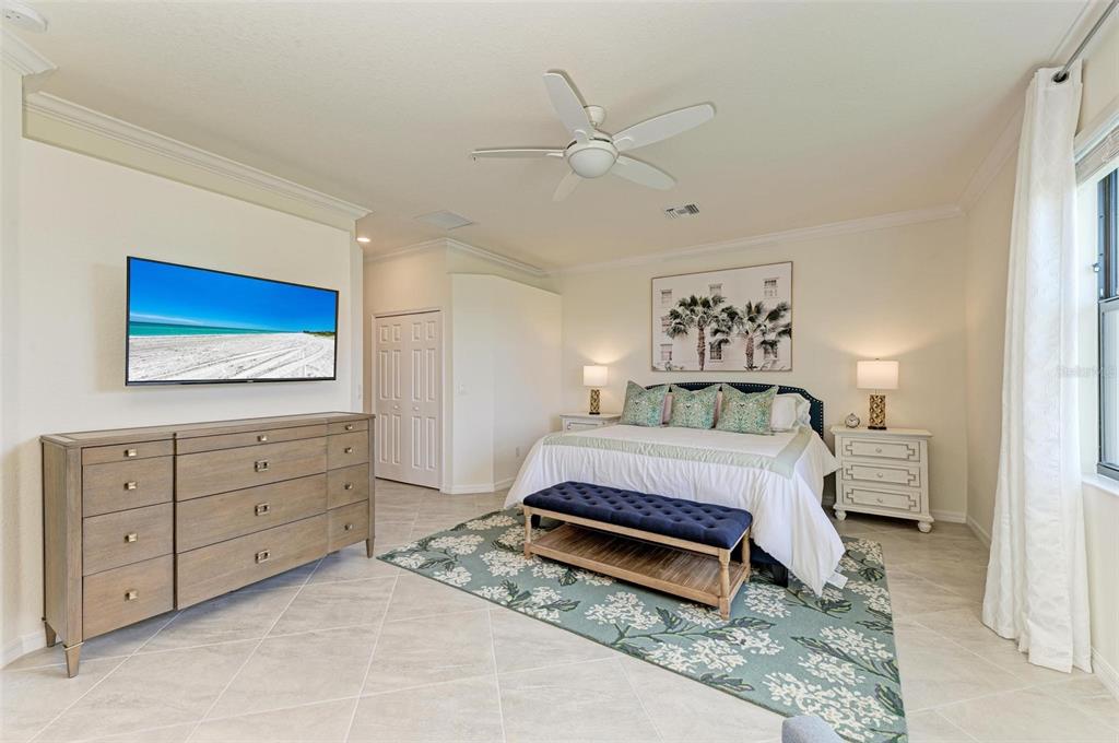 6086 Worsham Lane, Unit 103 Bradenton, FL 34211 - Photo 21 of 60 a spacious bedroom with a bed and a chandelier