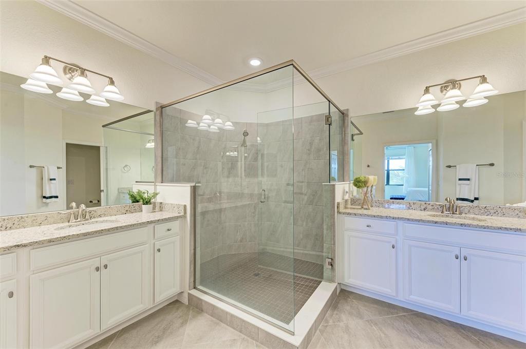 6086 Worsham Lane, Unit 103 Bradenton, FL 34211 - Photo 23 of 60 a bathroom with a shower sink vanity granite and mirror