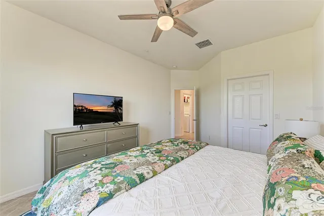 a bedroom with two beds and painting on the wall