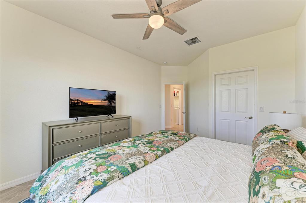 6086 Worsham Lane, Unit 103 Bradenton, FL 34211 - Photo 26 of 60 a bedroom with a bed and a flat screen tv