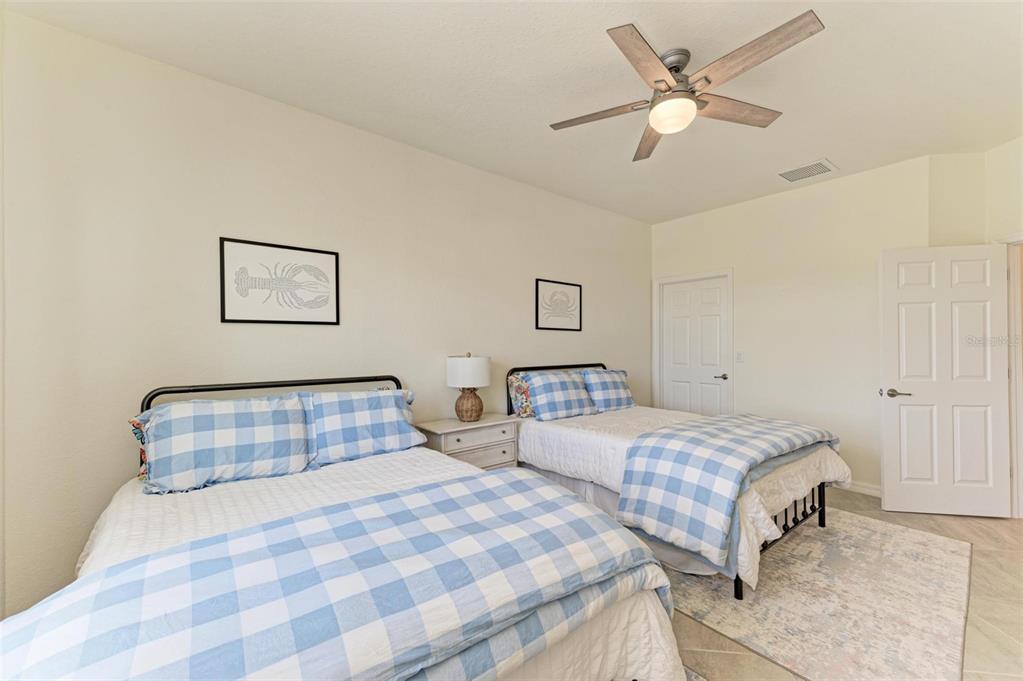 6086 Worsham Lane, Unit 103 Bradenton, FL 34211 - Photo 29 of 60 a bedroom with two beds and painting on the wall