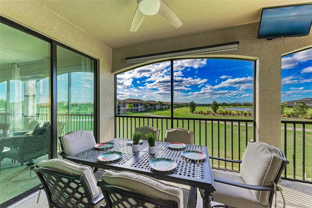 6086 Worsham Lane, Unit 103 Bradenton, FL 34211 - Photo 31 of 60 a view of a dining room with furniture large windows and wooden floor
