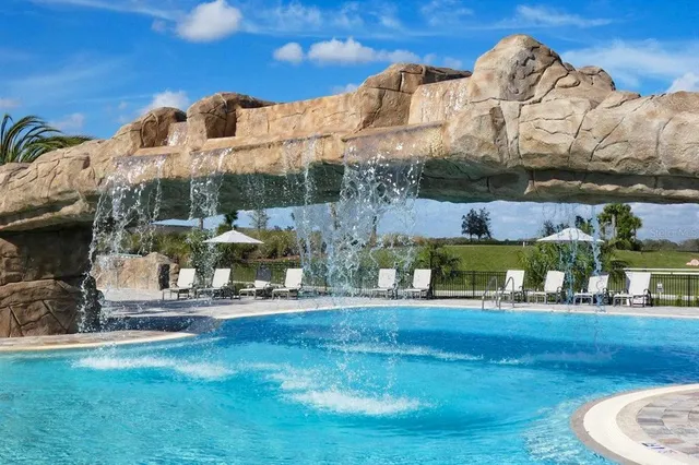 a large room with lots of furniture a rug appliances and a rug