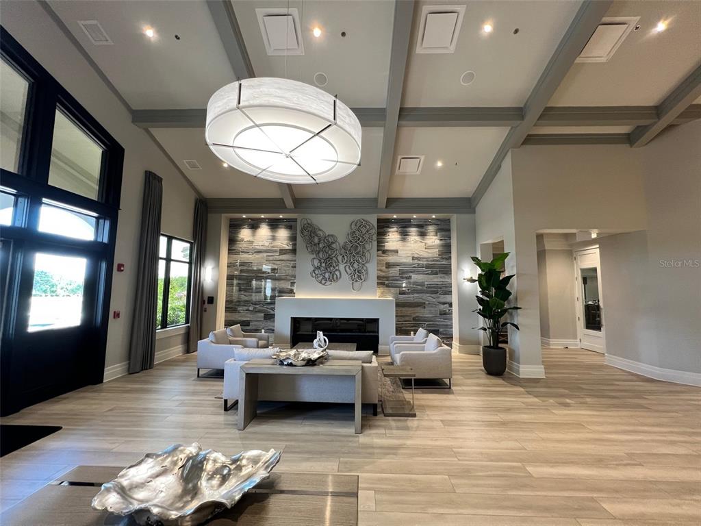 6086 Worsham Lane, Unit 103 Bradenton, FL 34211 - Photo 54 of 60 a living room with furniture chandelier and a fireplace