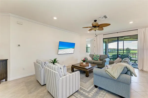 a living room with furniture and a chandelier