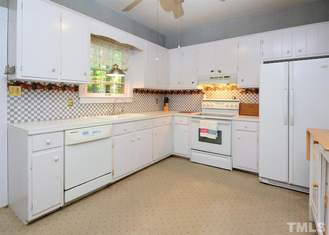 2114 Bahama Road Bahama, NC 27503 - Photo 12 of 21 a kitchen with white cabinets and white appliances