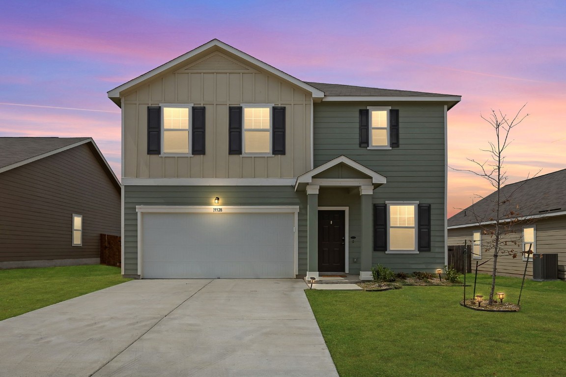 a front view of a house with a yard and garage