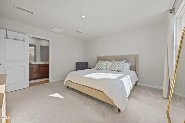 a bedroom with a bed and a refrigerator