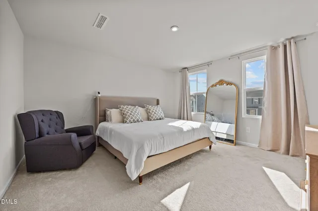 a bedroom with bed and a couch