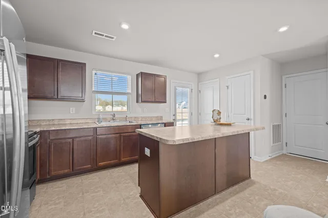 a kitchen with sink and cabinets