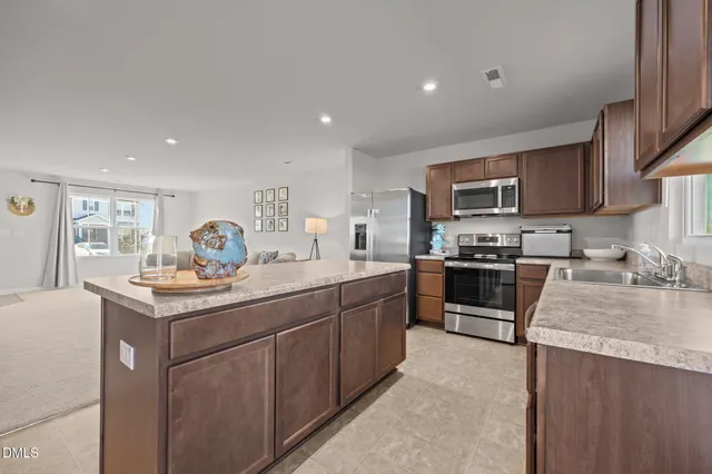 a kitchen with a sink stove and refrigerator