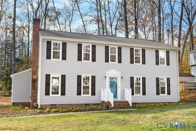 front view of a brick house with a yard