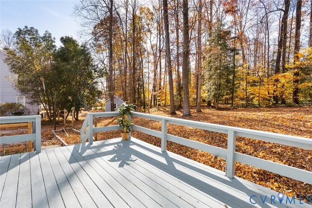 a view of a deck with a chair and floor to ceiling window