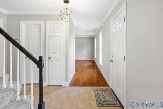 a view of a hallway with wooden floor and staircase
