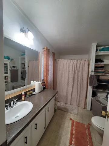a bathroom with double vanity and a mirror