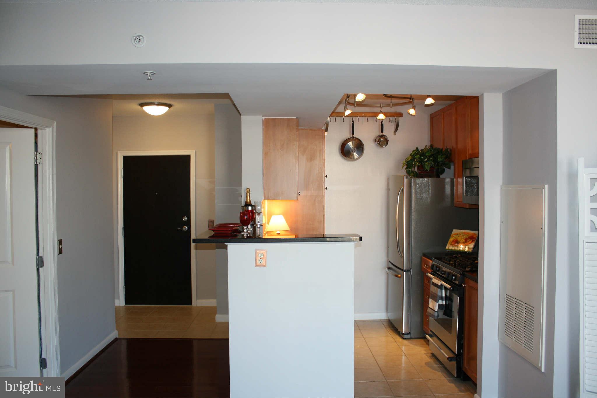 851 North Glebe Road, Unit 912 Arlington, VA 22203 - Photo 2 of 21 a view of a hallway and a dining rom with furniture