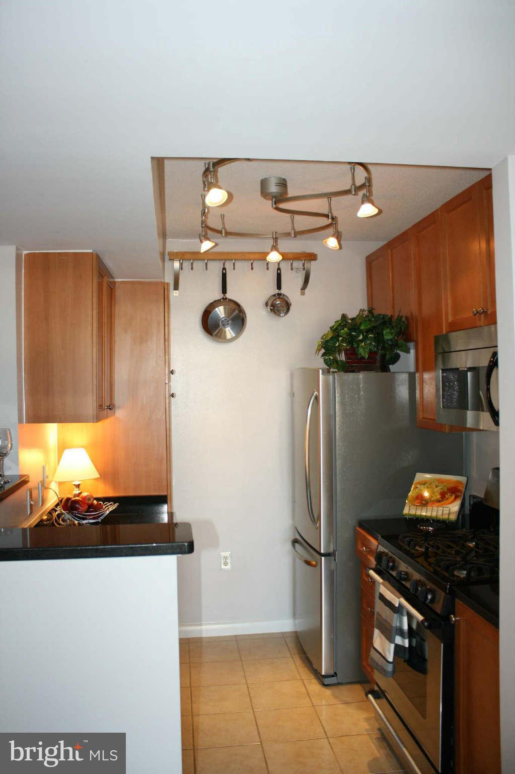 851 North Glebe Road, Unit 912 Arlington, VA 22203 - Photo 3 of 21 a kitchen with a refrigerator and a stove