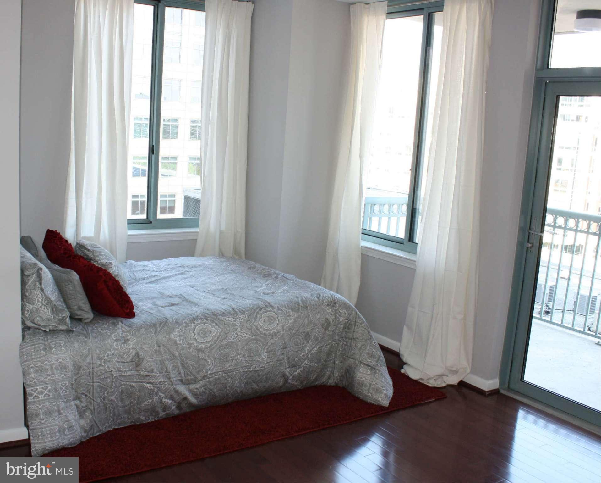 851 North Glebe Road, Unit 912 Arlington, VA 22203 - Photo 5 of 21 a bedroom with a bed and a window