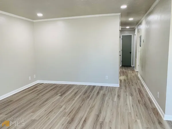 a view of hallway with wooden floor