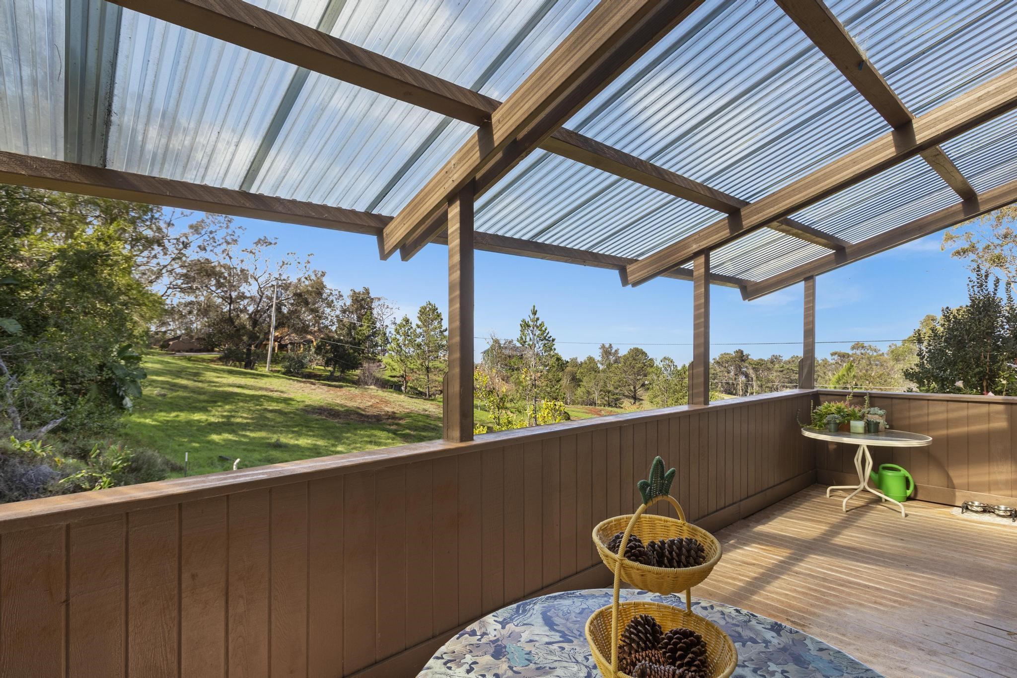 2450 Piiholo Road Makawao, HI 96768 - Photo 24 of 39 a balcony with table and chairs