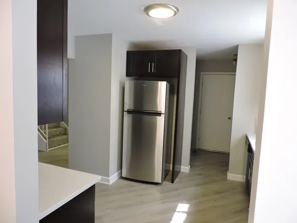 a view of a kitchen from the hallway