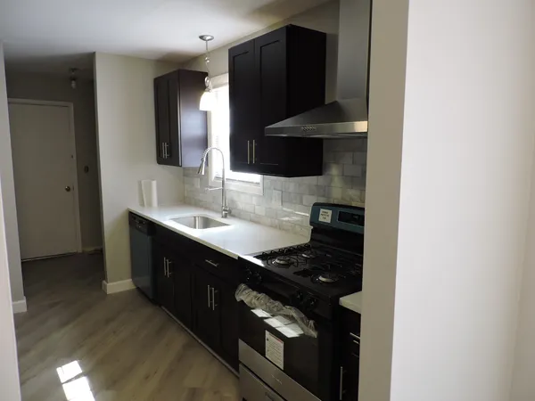 a kitchen with a sink and a stove top oven