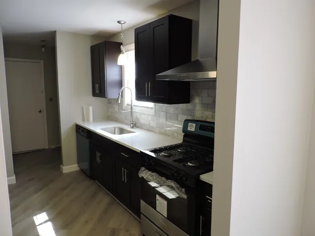 a kitchen with a sink and a stove top oven