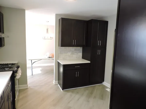 a kitchen with a wooden cabinets and a stove top oven