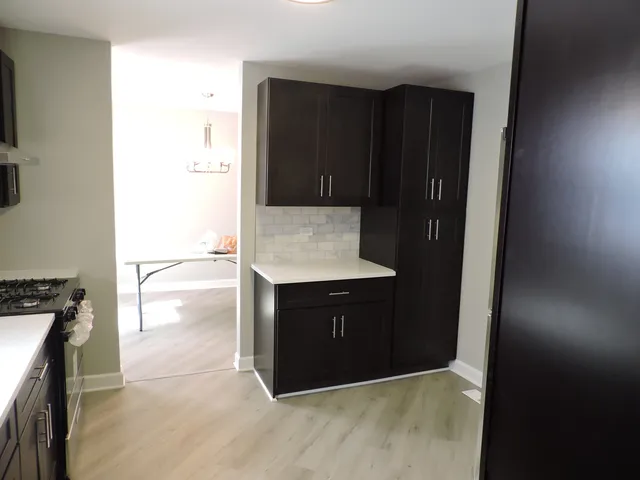 a kitchen with a wooden cabinets and a stove top oven