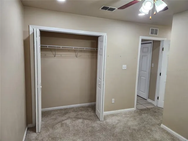 a view of room with window and ceiling fan