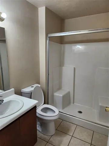 a white toilet sitting next to a bathroom sink