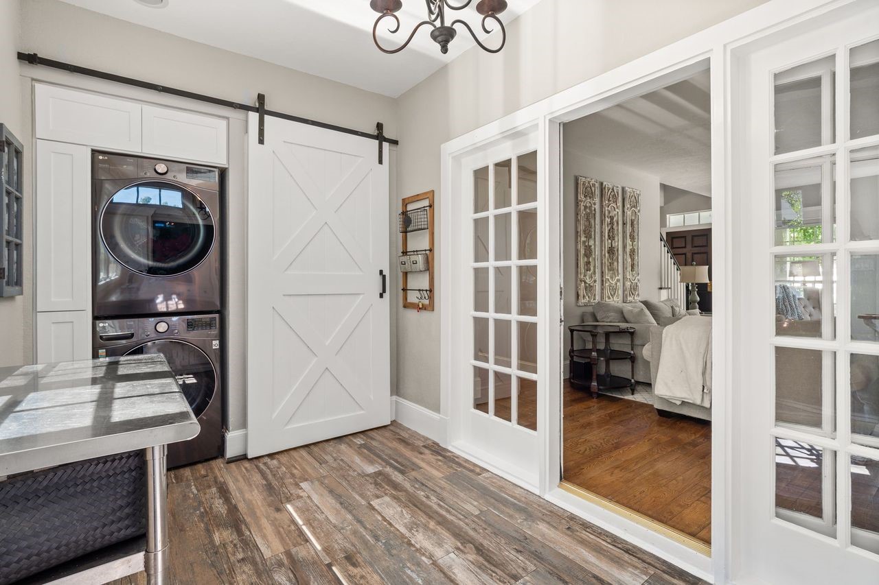 36 Wind River Drive Conroe, TX 77384 - Photo 26 of 45 A functional space with beautiful flooring and a washer and dryer that’s easily hidden behind the barn door. Cubbies for an organized mudroom on the left side of the door.